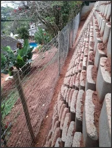 Reconstructed retaining wall and fence.